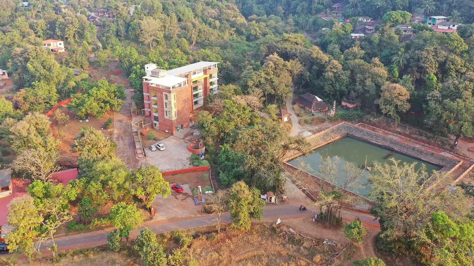 An overview of SeaFort Beach Resort surrounded by lush greenery and a water body nearby.