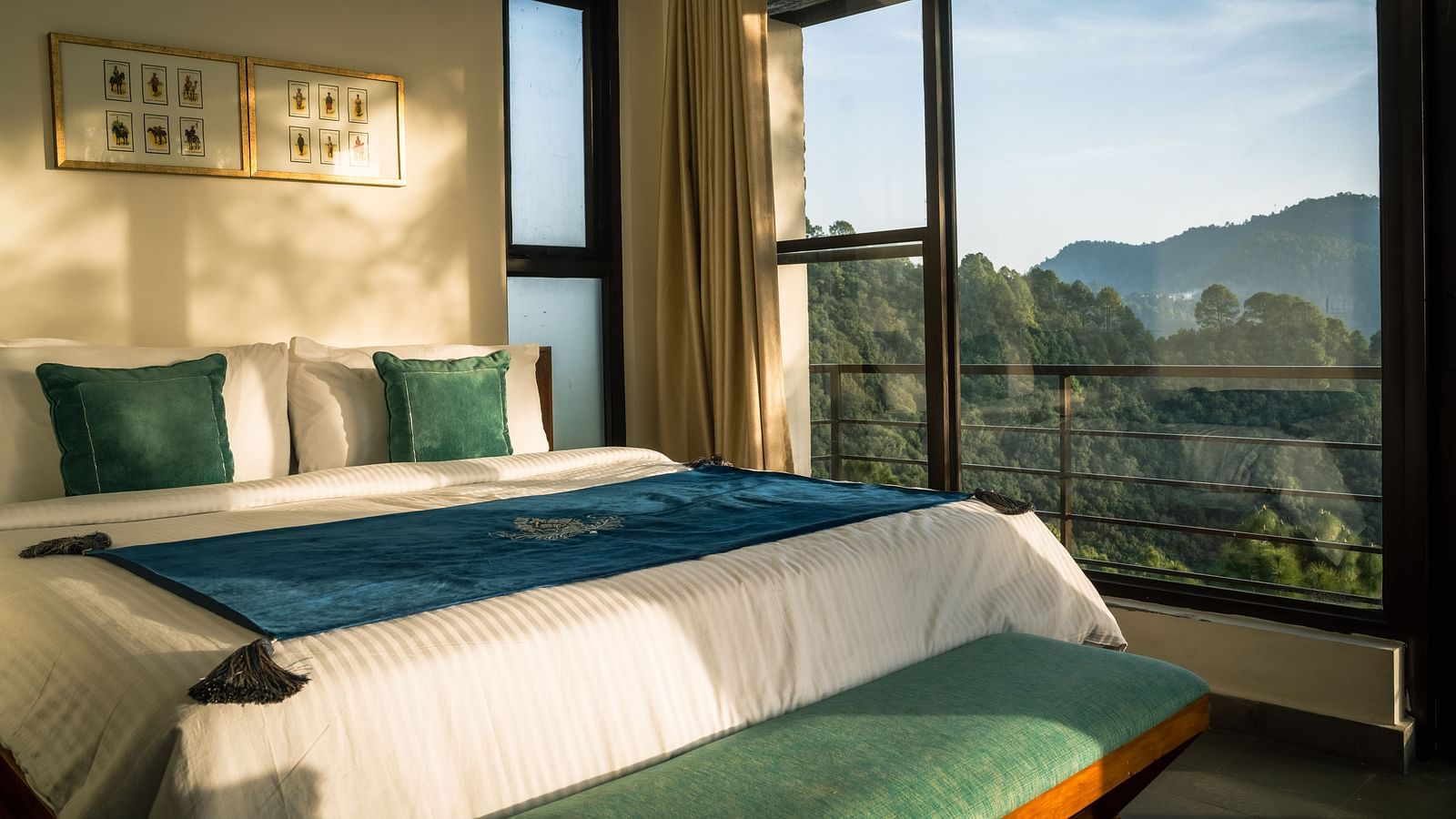 A bedroom with a balcony offering a mountain view and sunlight streaming in at BluSalzz Escapade Resort, Lansdowne