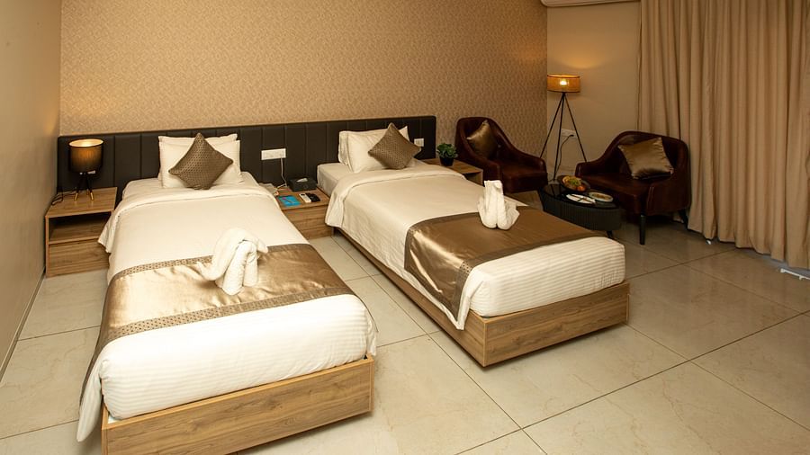 Hotel room featuring twin beds and elegant marble flooring