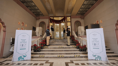 An image of an entrance to Heritage Village Resort and Spa where Annual Select boards are placed and people are gathering inside