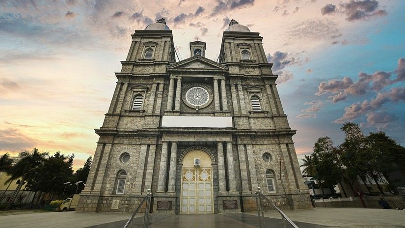 Church facade on a cloudy day with blue and gold sky in the background
