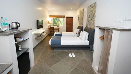 An image of a bedroom with twin beds and other room amenities - Argo By Trance, Goa