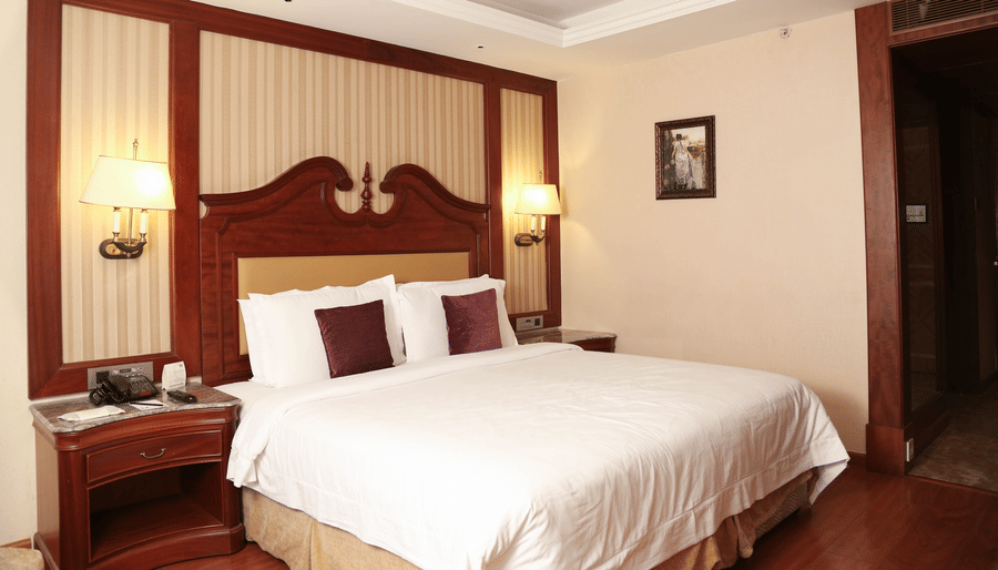 Cosy room with king size bed and modern interiors atstay stay rooms at hablis hotel, chennai.