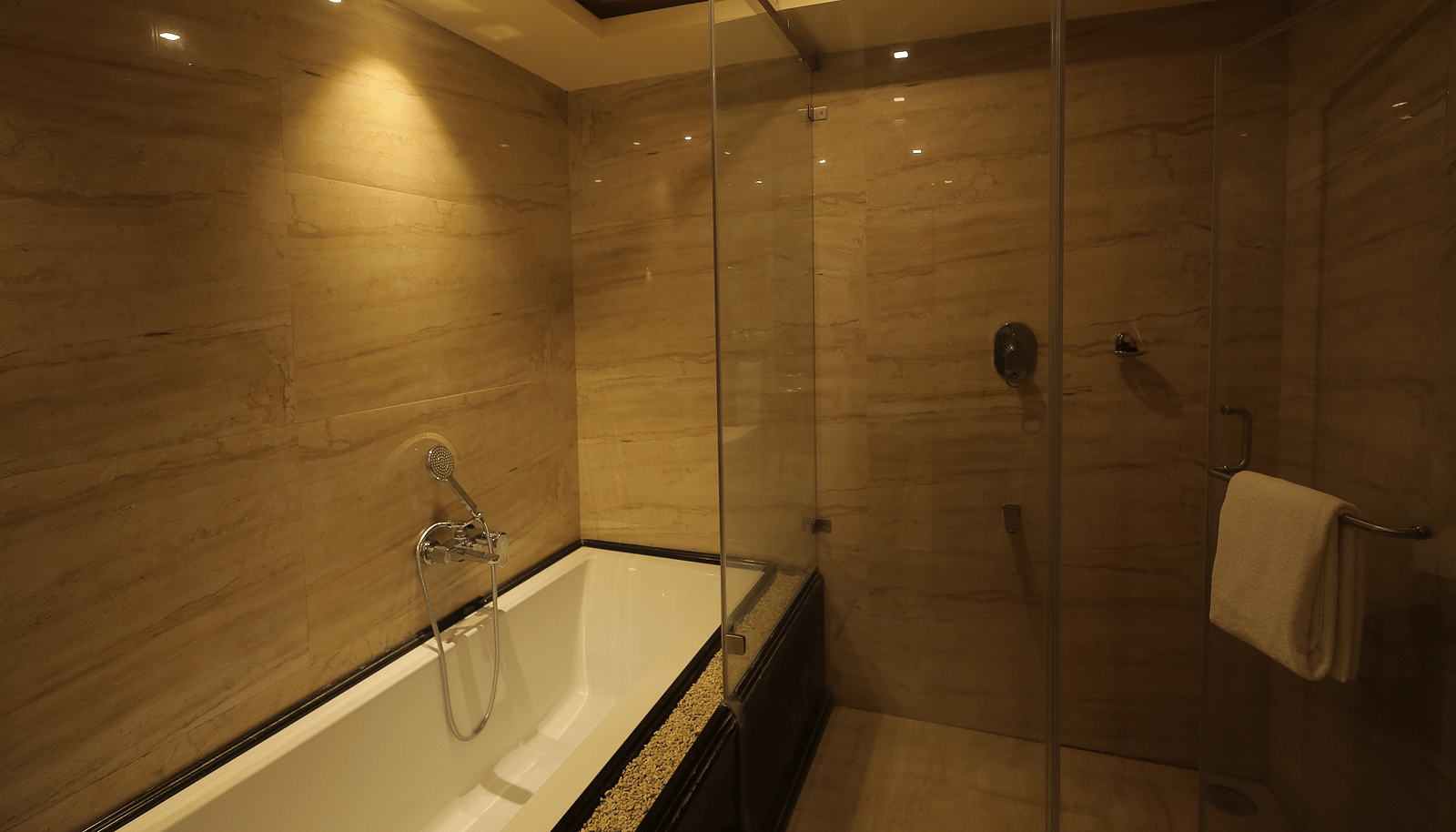 An image of a bathtub in a bathroom - Sathyam Grand Resort