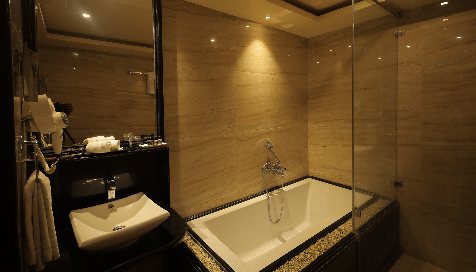 An image of a bathtub in a bathroom - Sathyam Grand Resort