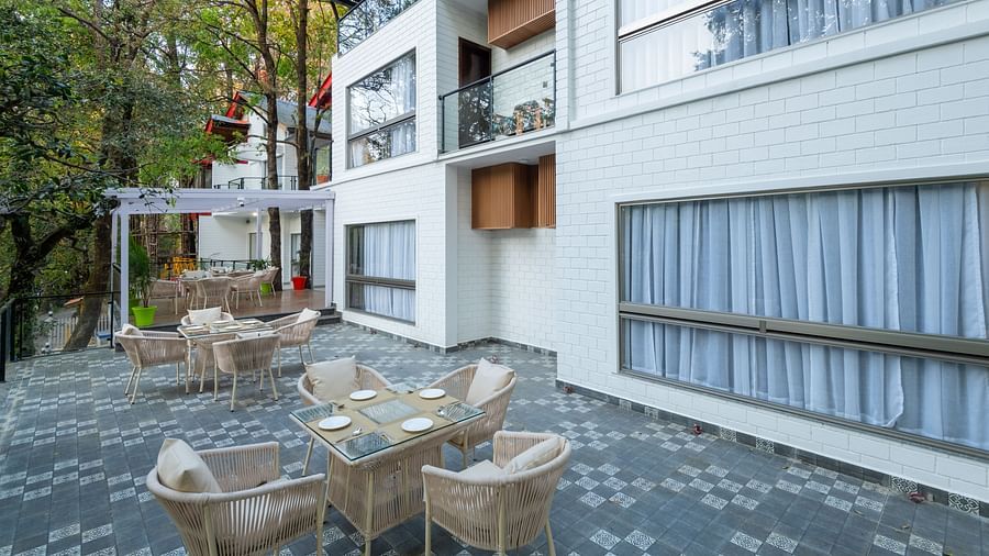 The exterior of DLS The Emerald, Nanital featuring the building structure of the property and chairs and tables in front of it