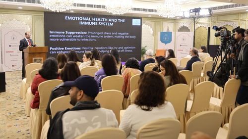 A group of people in a golf event looking towards a presentation at the centre of the stage - Heritage Village Resorts and Spa