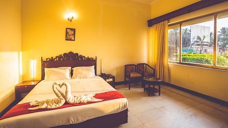 Premium Room at Paradise Isle Beach Resort, Udupi with a double bed and garden views from the window