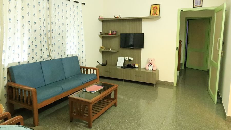 A shot of a living room with a couch, coffee table, and TV.