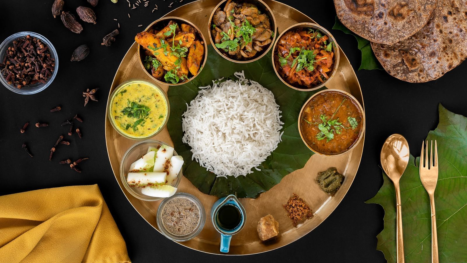 Authentic North Indian thali at The Patio in Haridwar with rice, chapati, and assorted vegetarian curries.
