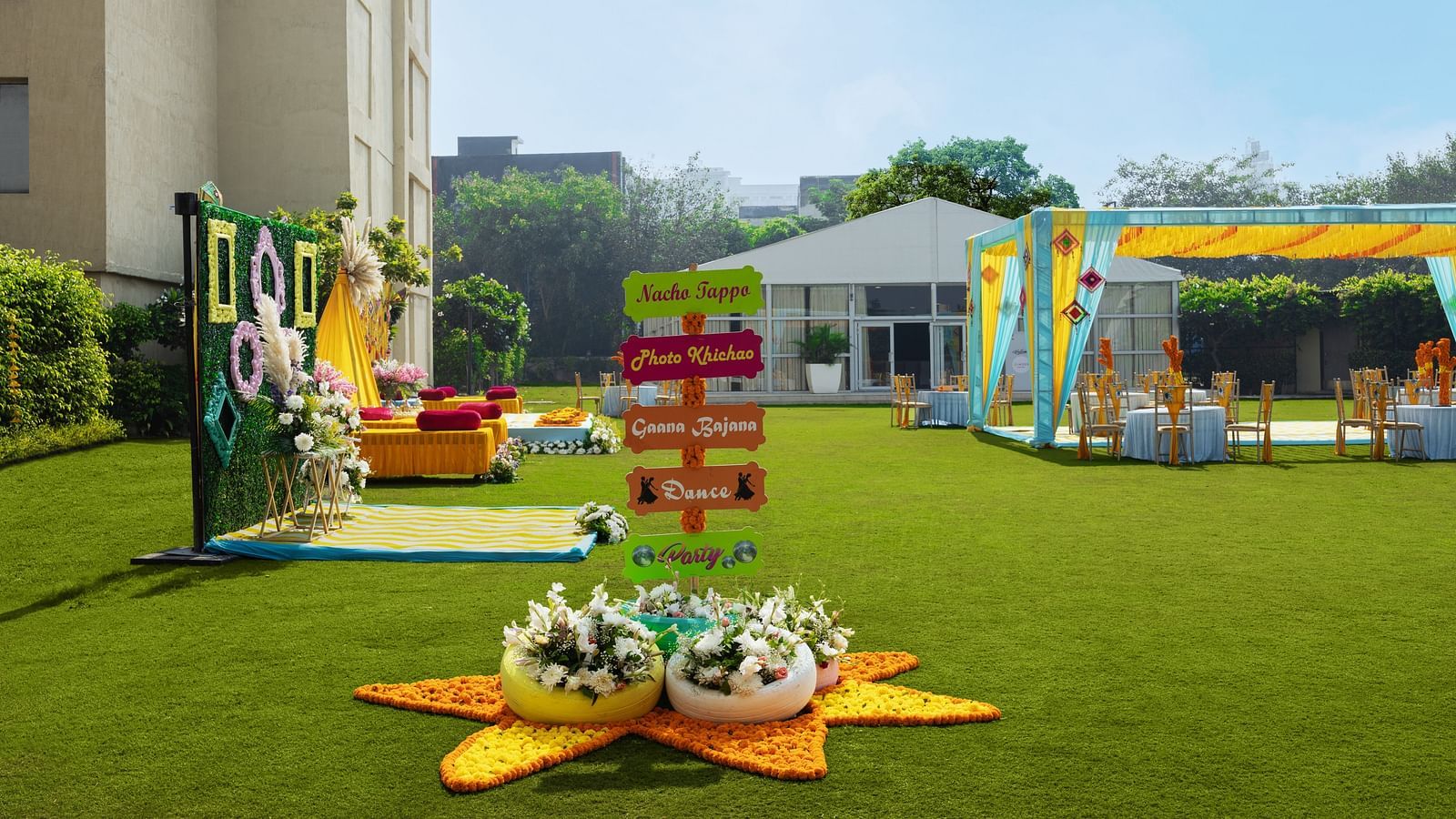 a view of a lawn with decorations and a canopy on the right side - The Hideaway Banquets & Lawns, Greater Noida