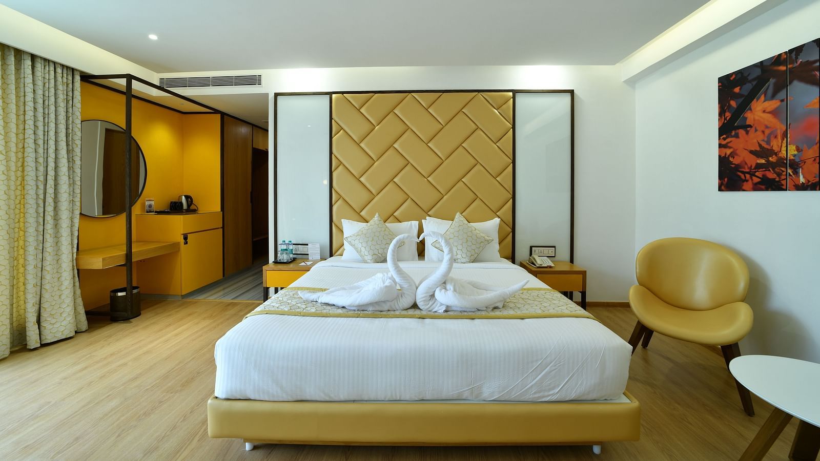 An image of bedroom with a tea & coffee maker and a portrait hanging on the wall -The President Hotel, Kumara Park, Bangalore