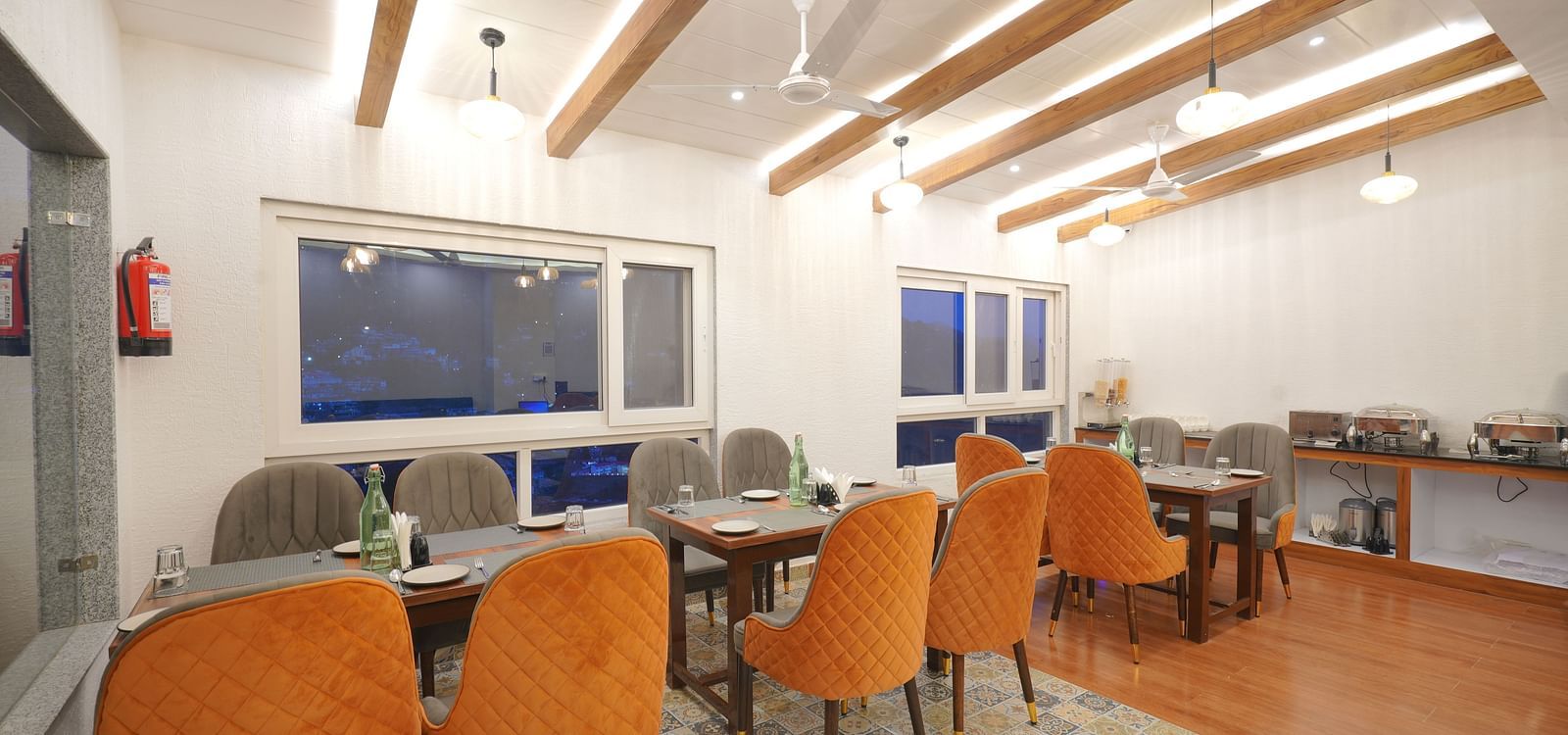 Dining seating of a restaurant at DLS Oak Bush, Mussoorie.