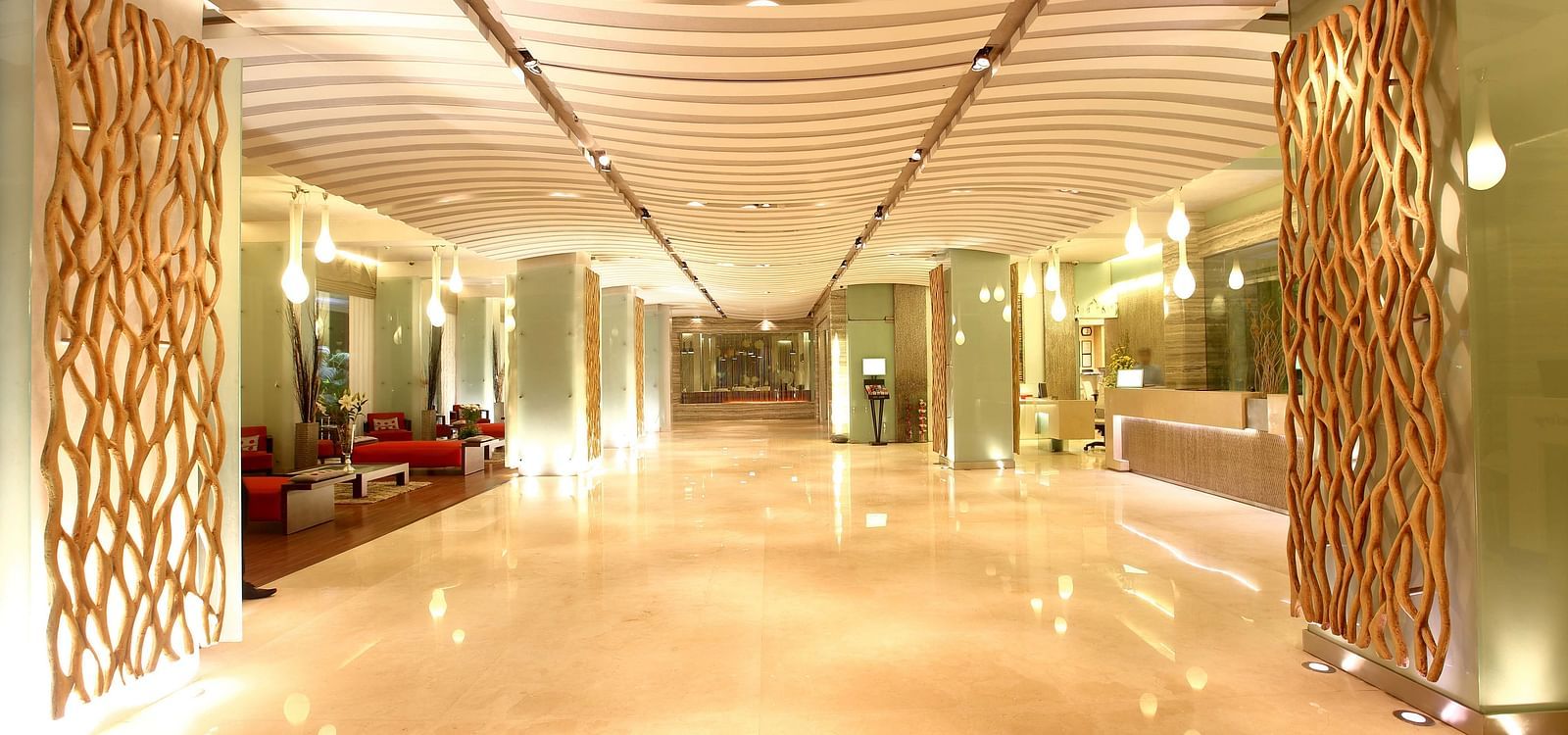 Image of the lobby at our hotel that is well-lit and has sofas on the left side. | Mirage Hotel