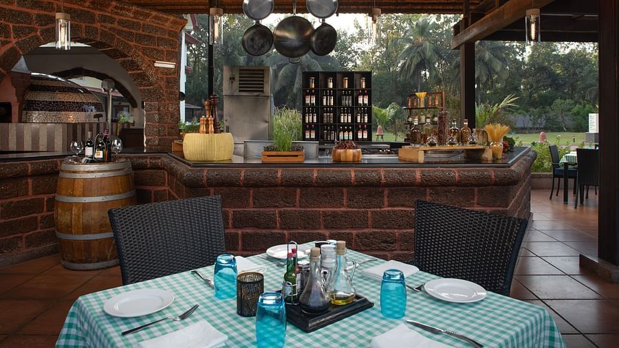 Salute, our Italian restaurant looks serene and friendly with its pleasing interiors and open view to nature - Kenilworth Resort and Spa