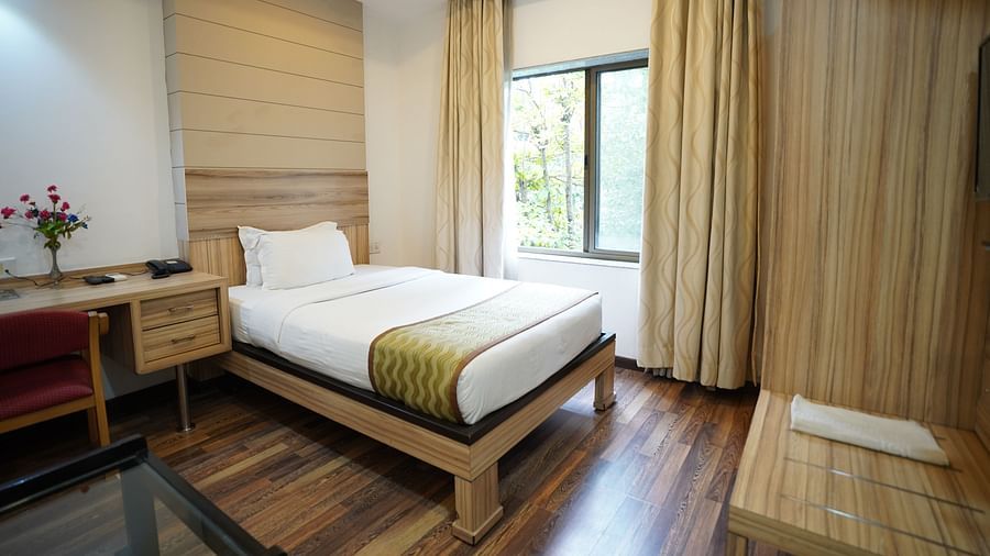 an image of a standard room with a single bed and a window at  City Centre Residency, Bangalore