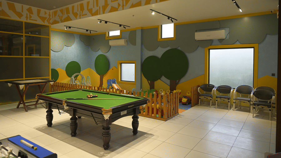 An indoor games room featuring billiards at Hotel Sonar Bangla, Mayapur.