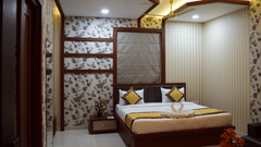 A modern luxury hotel bedroom in Varanasi, showcasing elegant decor, ambient lighting, and comfortable furnishings available through exclusive Varanasi hotel deals - Hotel Uday Palace.