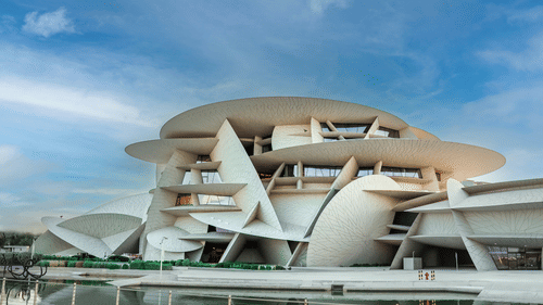 Facade image of Museum of Islamic Art in Qatar with blue sky in the background near Al Corniche Doha