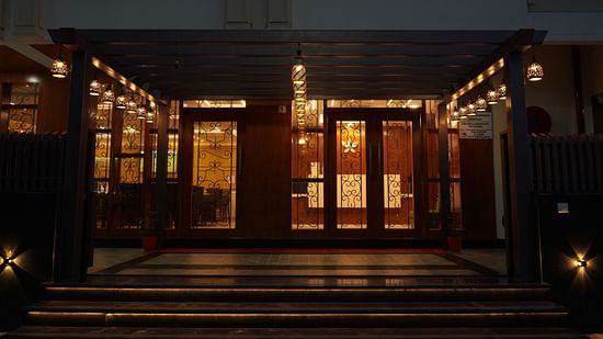 An image of an entrance to Five Elements Hotel, Jodhpur which is well lit and also giving a sneak peak of the dining area