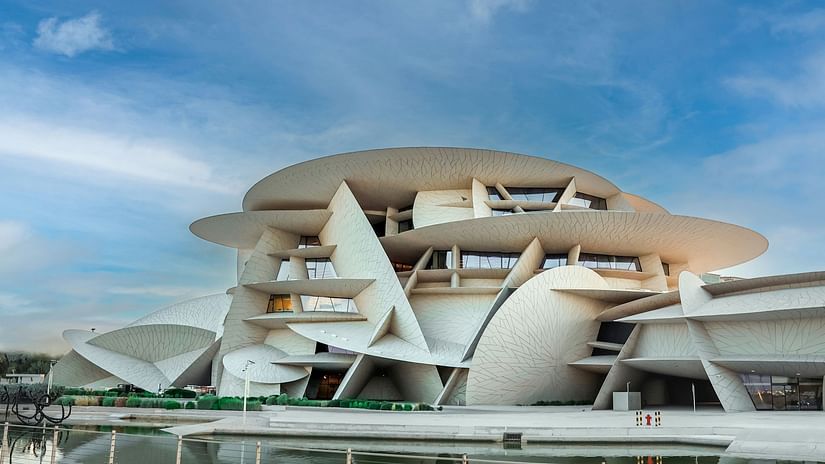 Facade image of Museum of Islamic Art in Qatar with blue sky in the background