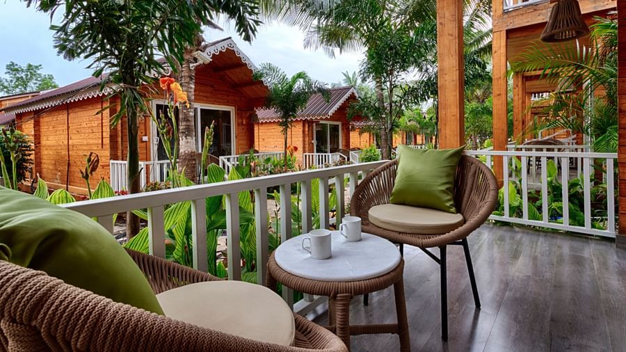 Outdoor seating area surrounded by greenery at Aralea Beach Resort by Stone Wood, Morjim
