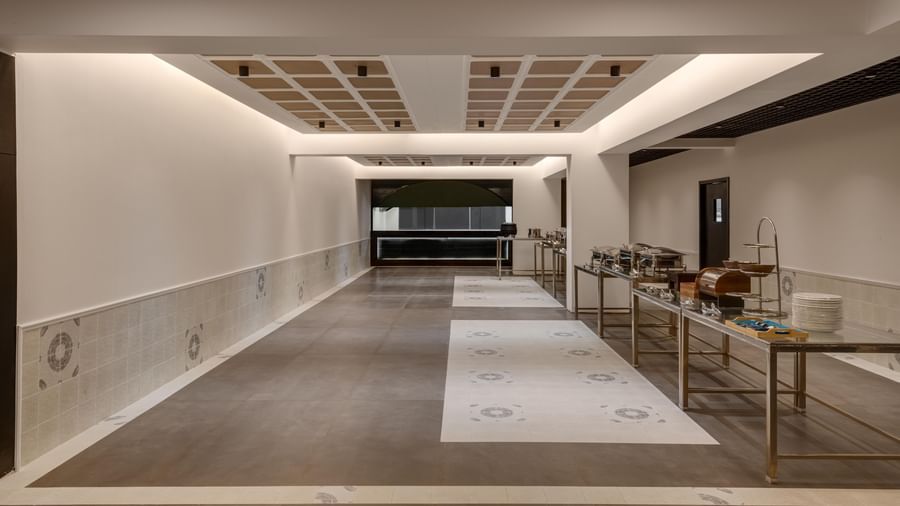 Spacious kitchen area at Voyage Milestone Hotel and Banquet with well-lit ceiling.