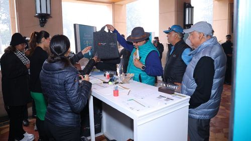 A group of people at annual golf club celebration where few of them are holding a bag from Heritage Village Resorts & Spa
