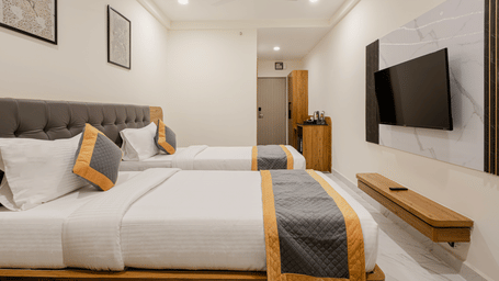 Stylish cosy twin room with twin beds and warm lighting at Lemonridge Hotels, IDPL Balanagar