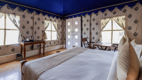 Swiss Classic Tent with Hill View interior featuring a bed and blue canopy ceiling at Valley by Grassfield.