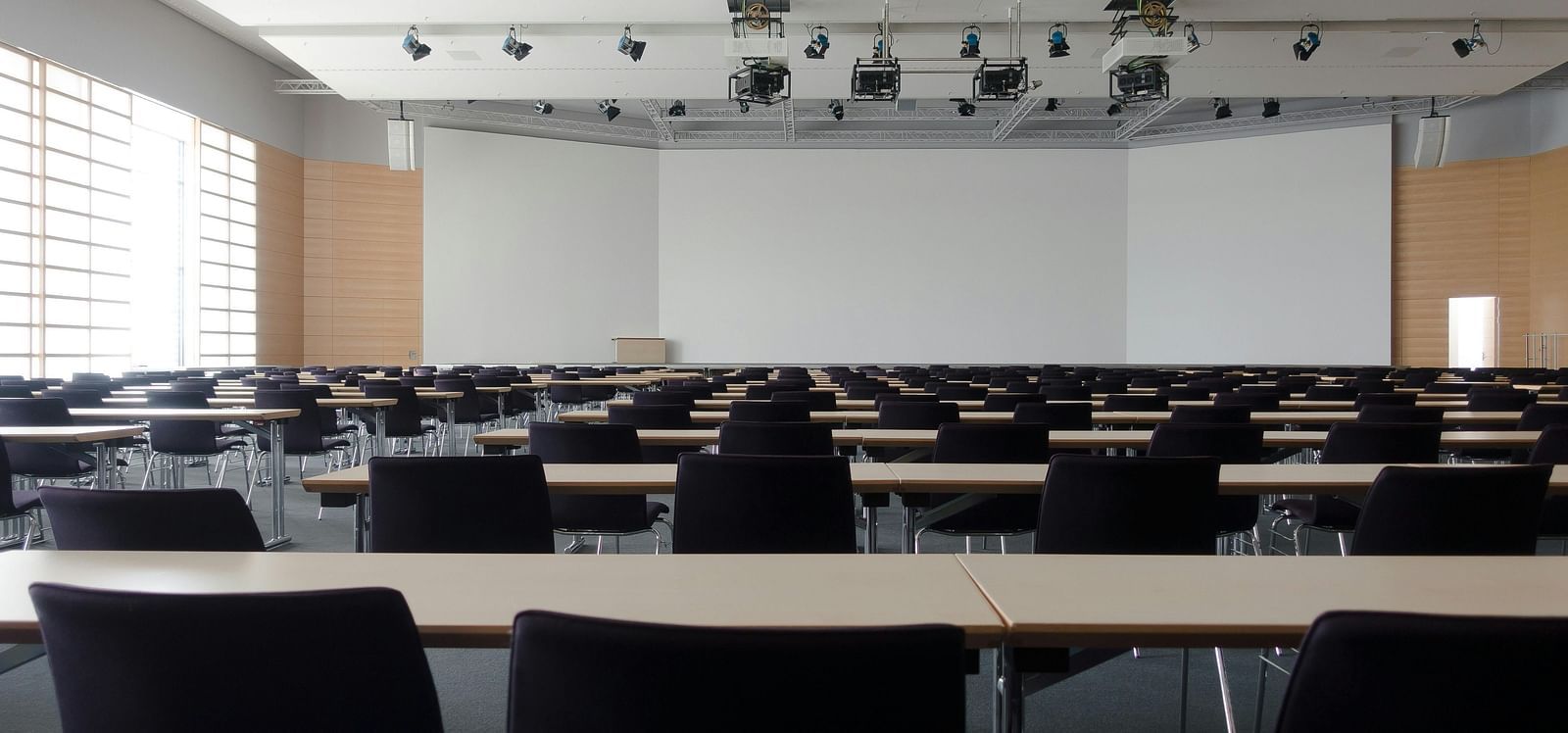 an image of conference hall with chairs and tables 