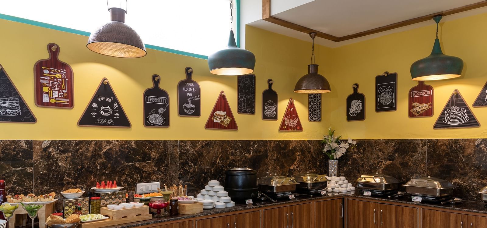 A colourful buffet display, featuring a variety of dishes in a contemporary restaurant setting | Inde Hotel Cyber City 