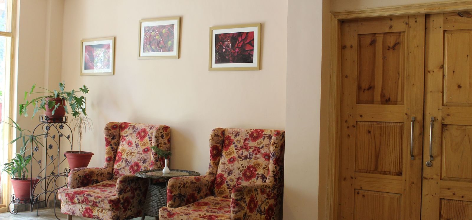 view of the elegant seating area with plush chairs and wooden accents at Dagshai Manor Kasauli - Inde Hotels