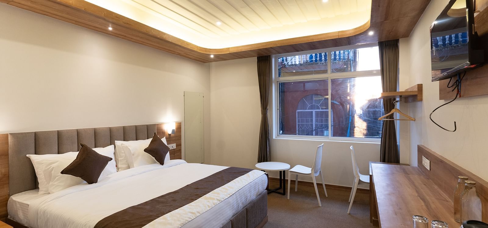image of the standard room with a window in the corner at The Soma Hotel by Avianna Group, Darjeeling