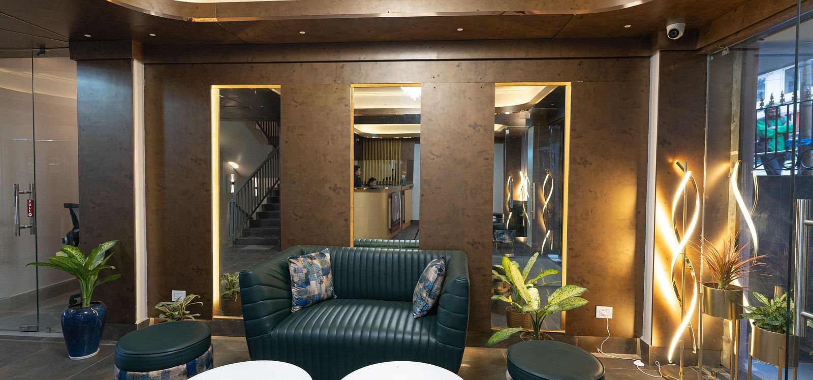 image of the lobby with teal coloured sofa set at The Soma Hotel by Avianna Group, Darjeeling