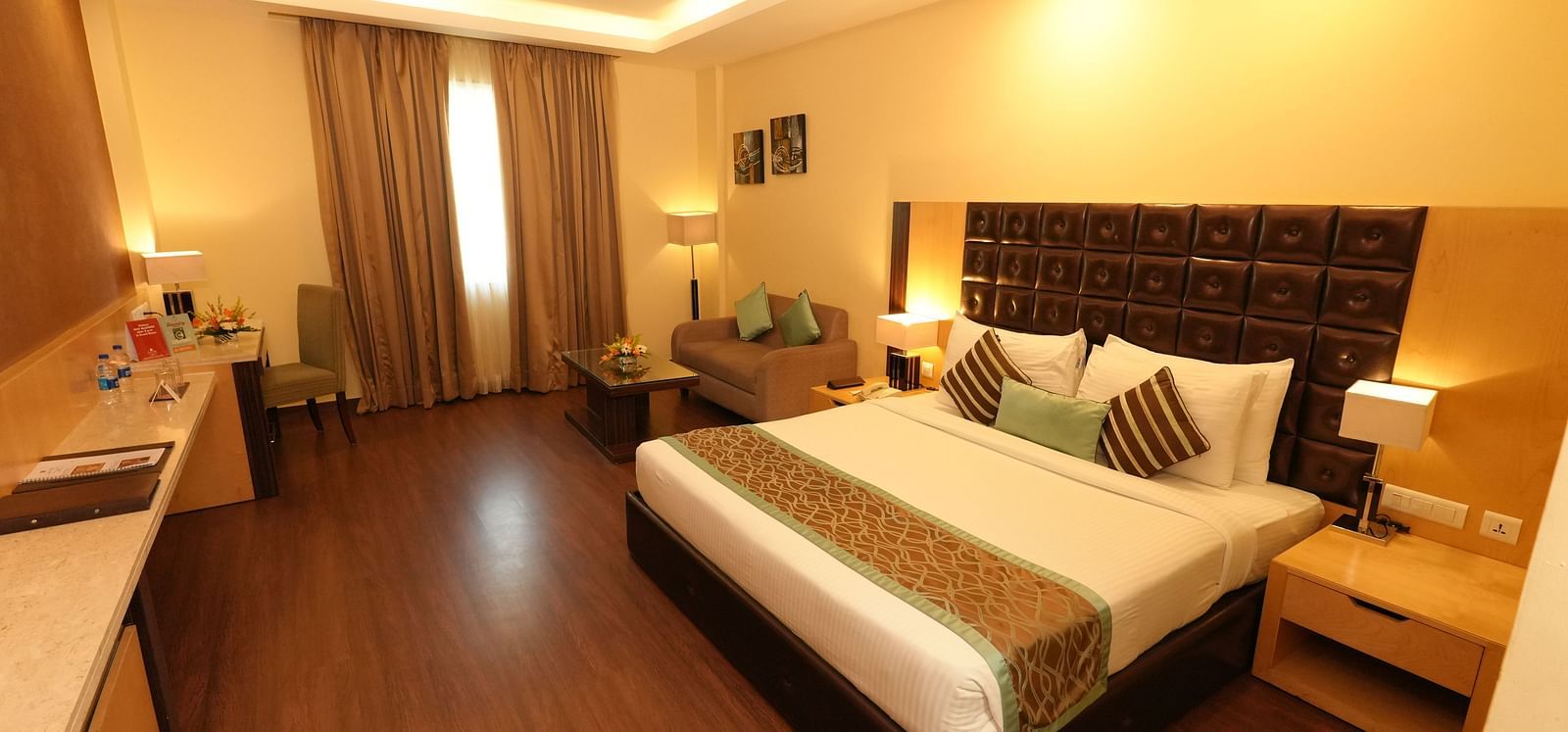 Guest room featuring a large bed and bedside tables - Grand Plaza Lords Inn Jammu