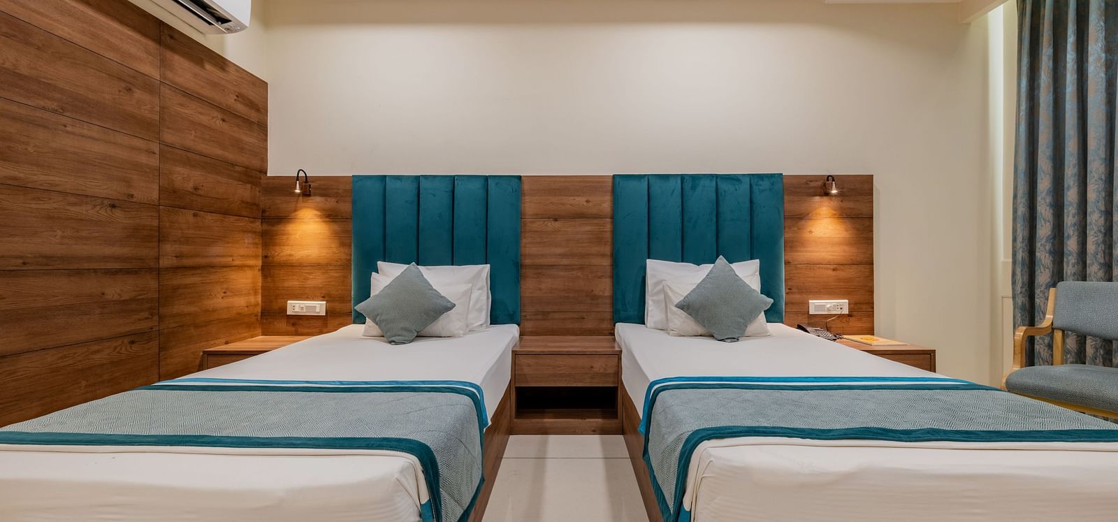 King Twin Bed Room with two single beds, wood-panelled walls, and soft lighting at Hotel Highway King, Bilaspur.