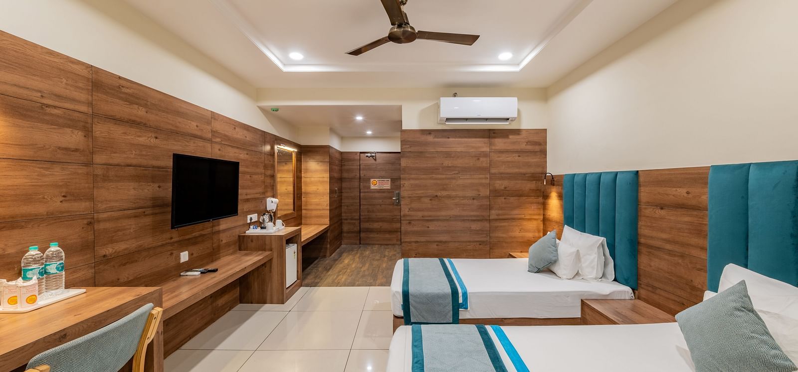 King Twin Room with wood-accented interiors, work desk, and wall-mounted TV  at Hotel Highway King, Bilaspur.