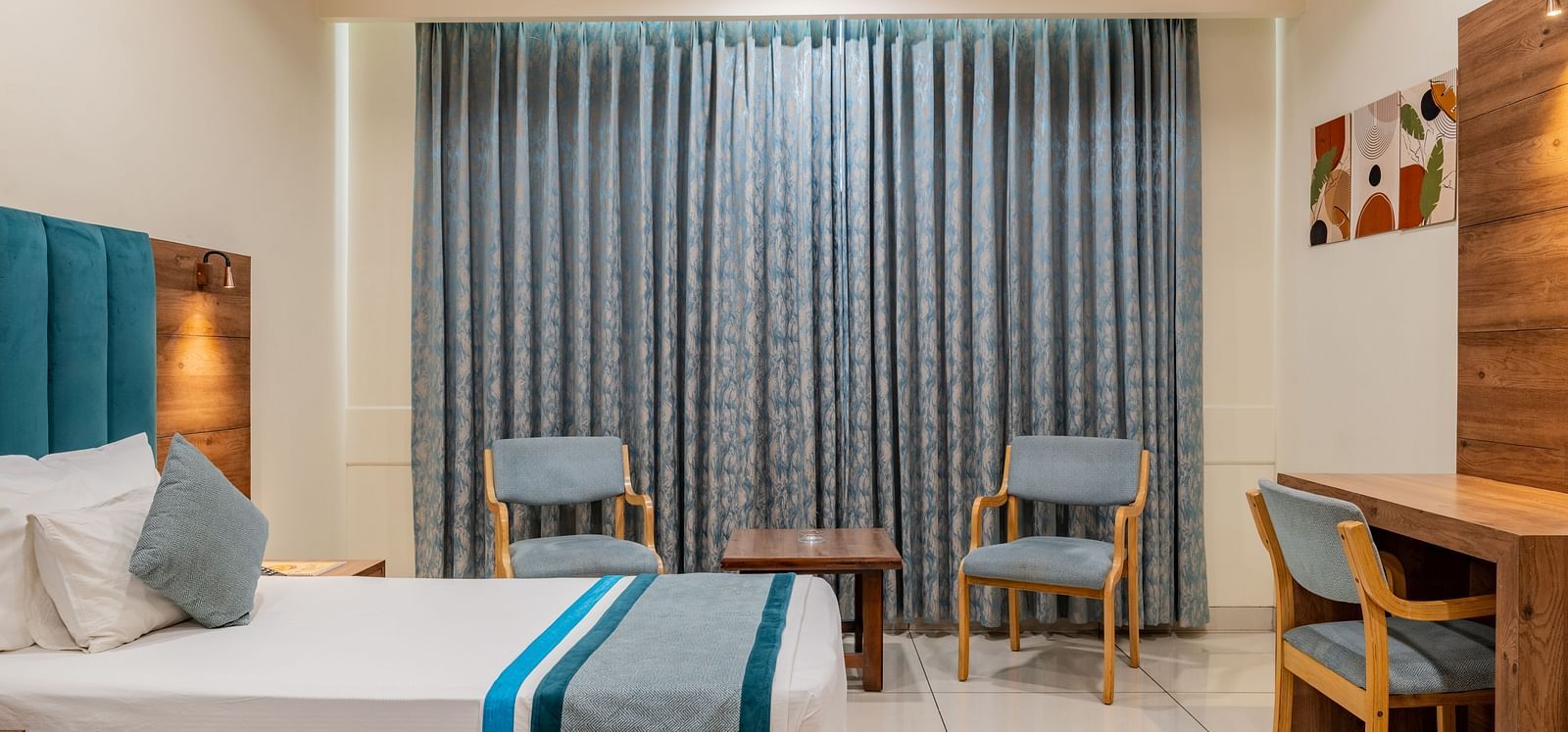 KIng Twin Bed Room with curtain-lined windows and coordinated seating area at Hotel Highway King, Bilaspur.