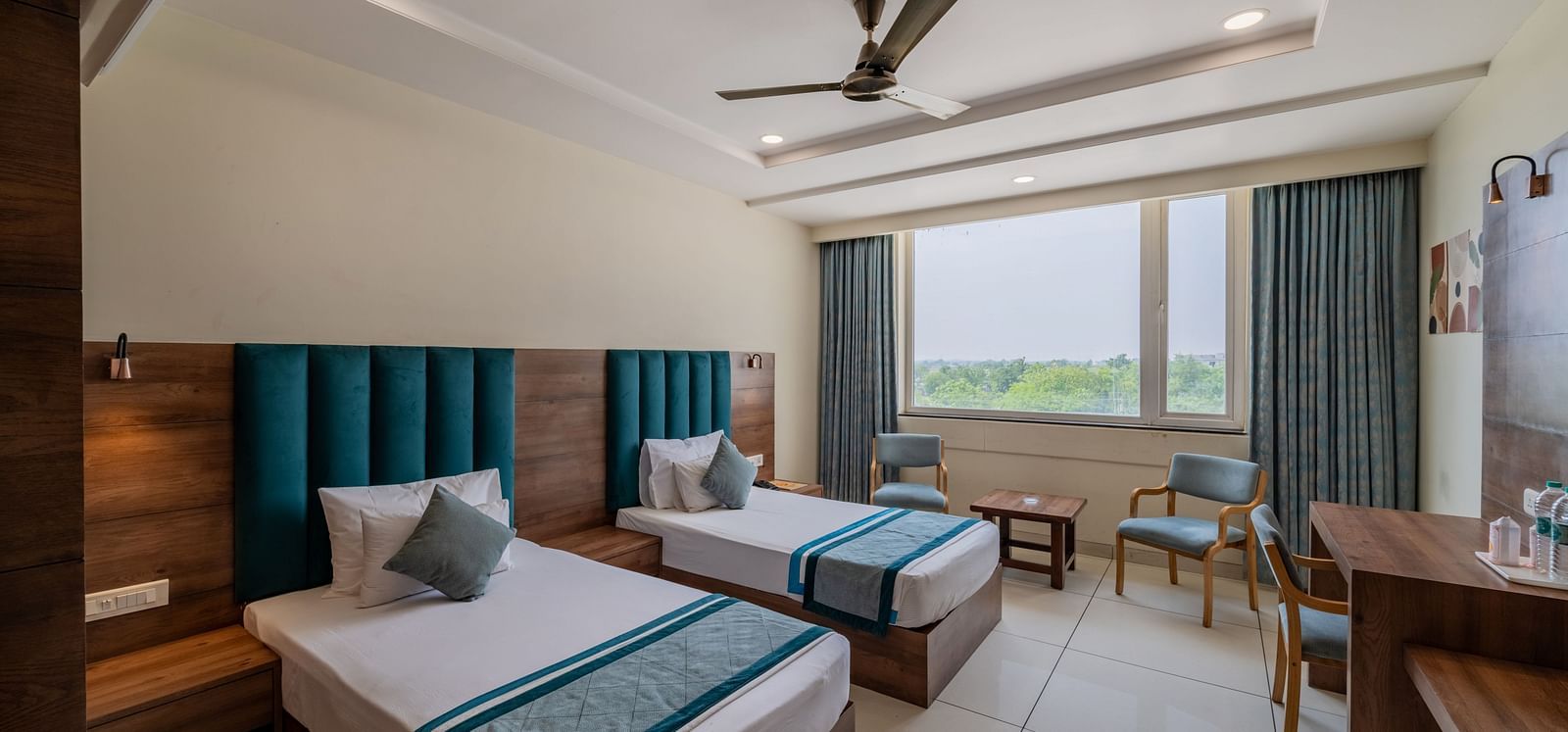 Spacious King Twin Bed Room with window seating, work station, ceiling fan, and modern amenities at Hotel Highway King, Bilaspur.