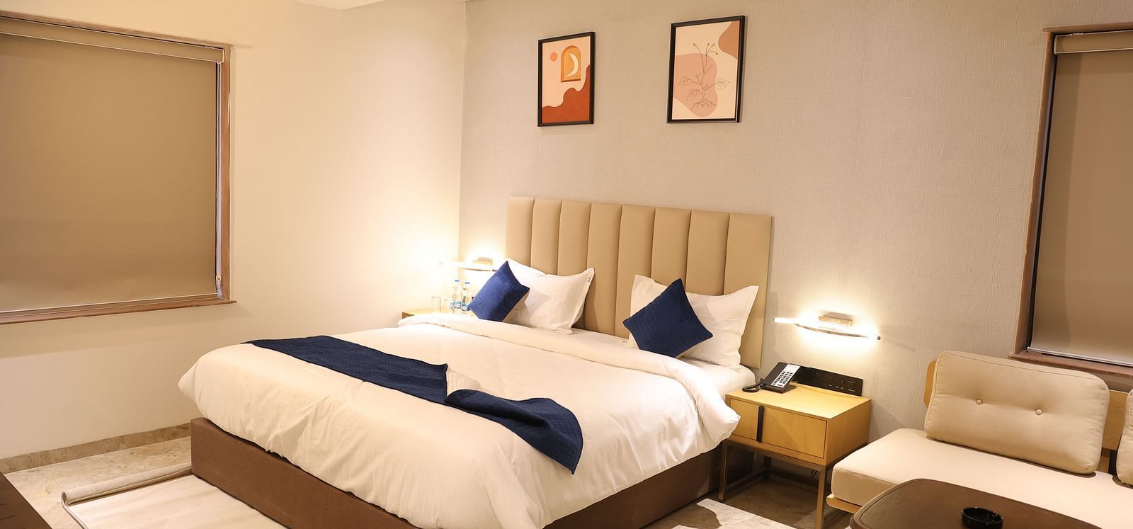 A luxurious Deluxe Room at Lords Eco inn Jamnagar Maheshwari Nagar showcasing a comfortable bed and contemporary furnishings.
