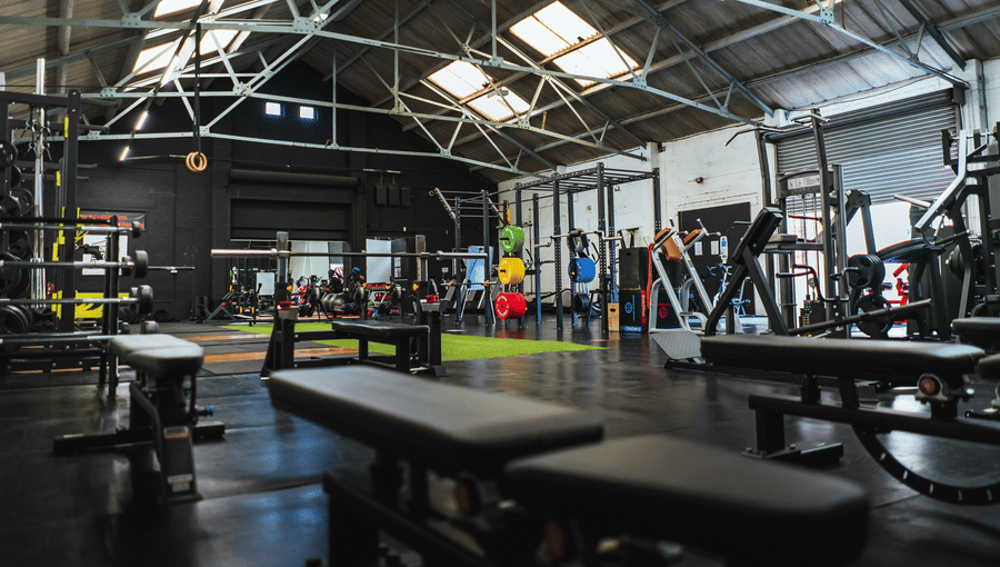 A well-equipped fitness centre with workout machines and benches at Bhavanis Vista By Icon Hosur.