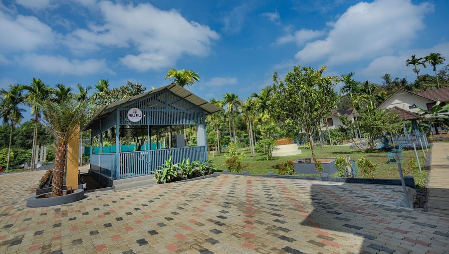 alt-text Exterior view of property with open area and trees in the background at Feel Free Retreat, Wayanad