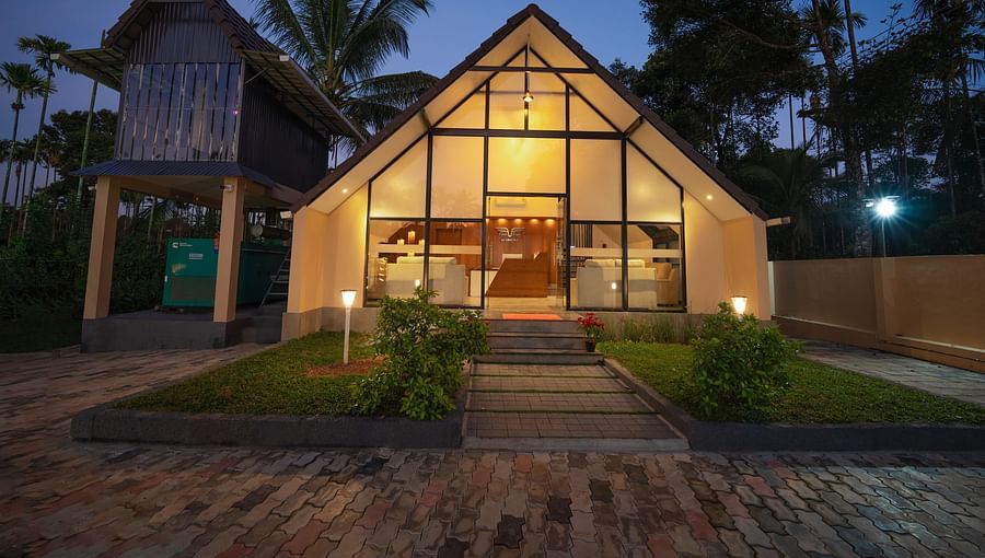alt-text Night view of property with tress behind it at Feel Free Retreat, Wayanad