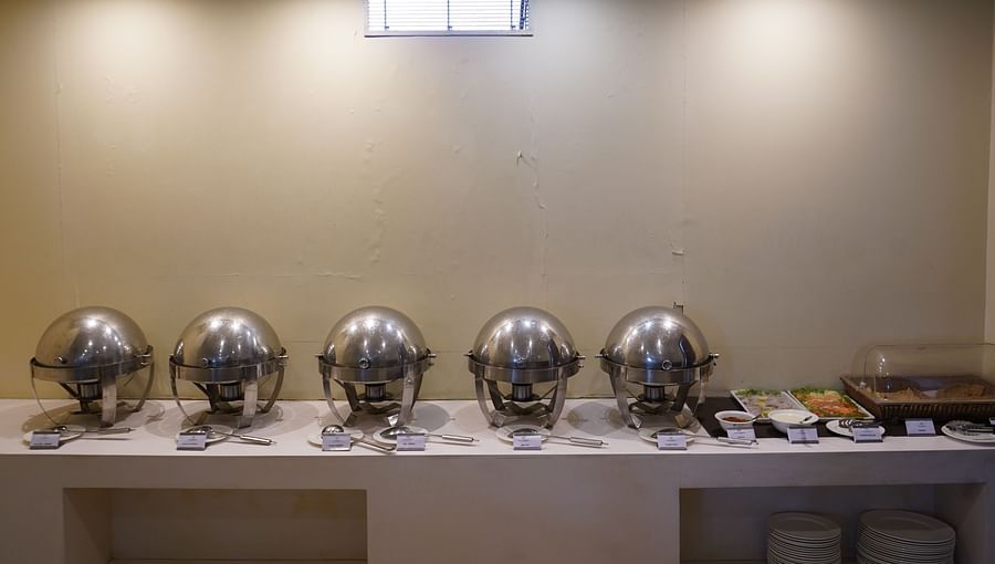 An image of a buffet area featuring several pots where food is kept in a restaurant at Five Elements Hotels North Avenue, Delhi