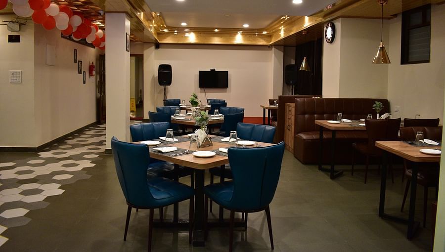 alt-text dining area with attractive interior and indoor seating arrangement decorated with red and white balloons at Hotel Montana Vyoo