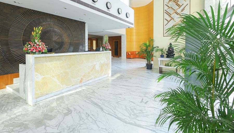 Side view of the lobby with green plants in the corners at Icon Premier Hotel by Bhagini, Devarabisanahalli