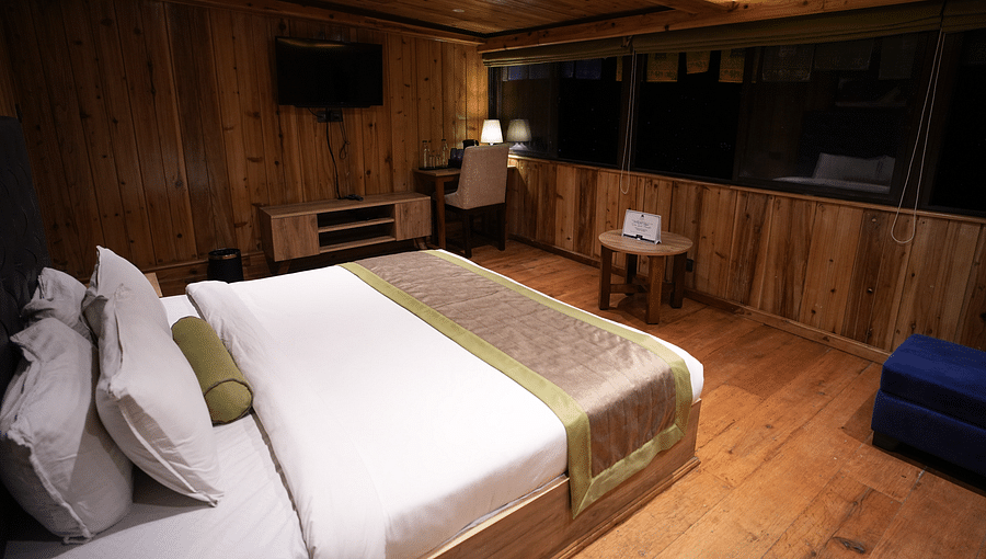 alt-text Cozy wooden room with a double bed and mountain view