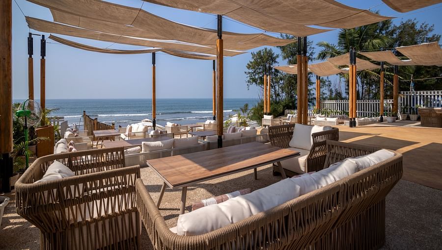 full view image of the saz on the beach restaurant at sibaya beach resort, morjim beach with covered seating arrangements