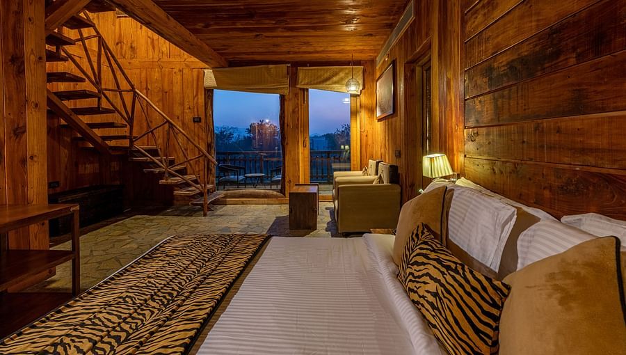 one of the duplex cottages in Ranthambore with a bed at one corner 3